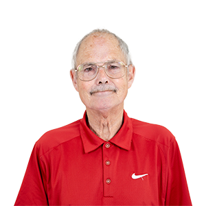 A photograph of CHAOS Radio presenter Dave Knowles; he is wearing a red polo shirt with a white Nike logo on one side, and silver-framed glasses.
