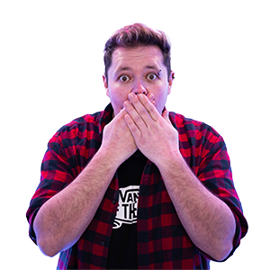 A photograph of CHAOS Radio presenter Nathan Hunkin. He is wearing a black and red checked shirt with a black 'VANS Off The Wall' tshirt underneath.