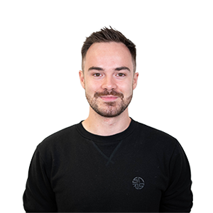 a photograph of CHAOS Radio's NewsWave Presenter and Reporter, Tom Howe. He wears a black jumper.