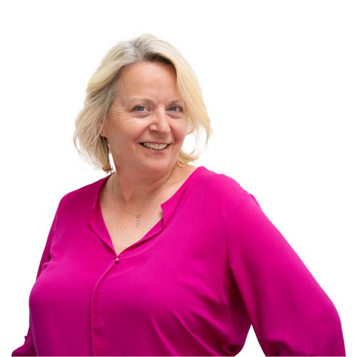 CHAOS Radio Presenter - Janice Rose - smiling at the camera, wearing a bright fuchsia blouse and silver necklace.